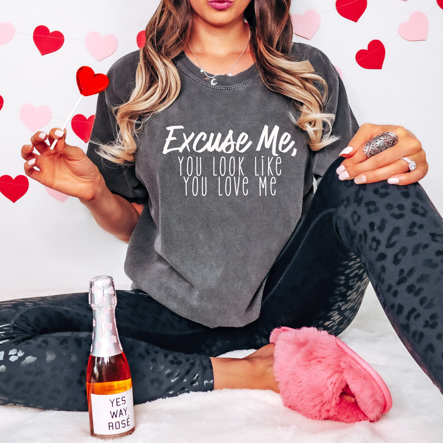 Trendy pepper-washed graphic tee featuring the playful text 'Excuse Me, You Look Like You Love Me' in a bold white font. Perfect for casual Valentine’s Day vibes or everyday wear with a touch of humor.