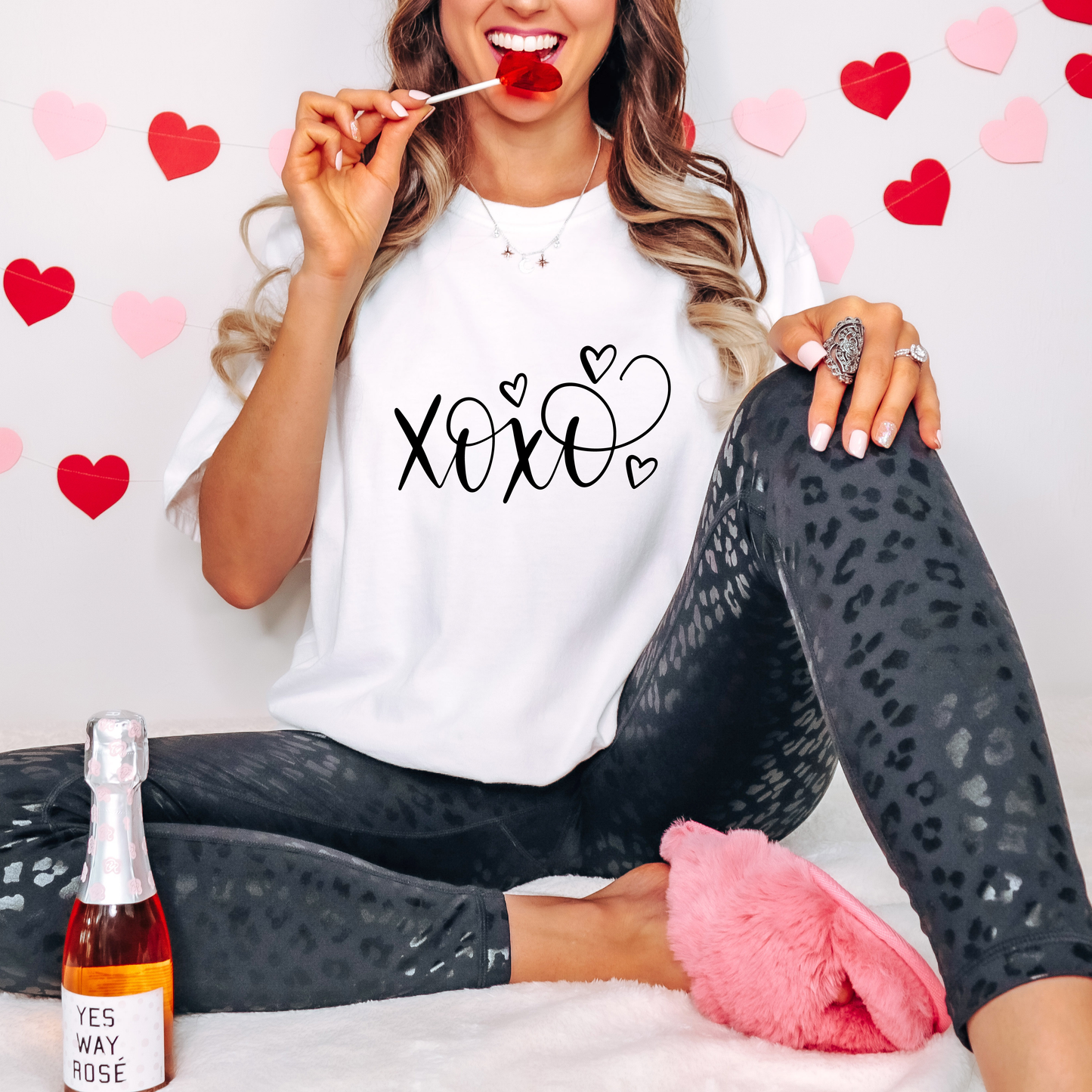 White Valentine’s Day graphic tee featuring the text 'XOXO' with heart accents for a sweet and casual festive look.