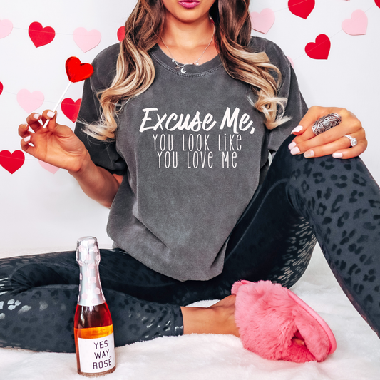 Trendy pepper-washed graphic tee featuring the playful text 'Excuse Me, You Look Like You Love Me' in a bold white font. Perfect for casual Valentine’s Day vibes or everyday wear with a touch of humor.